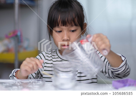 Cute little girl making DIY plaster and painting at home. Children paint on plaster sculptures with family on holiday. Imagination and creativity activities. 105686585
