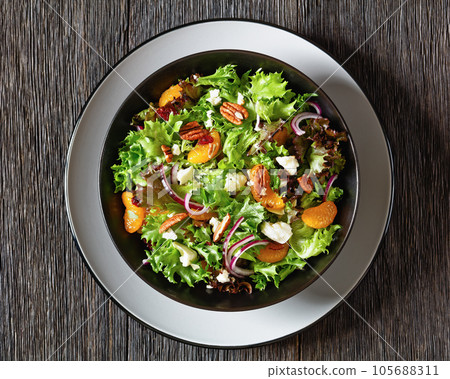 Mandarin Orange Salad in black bowl, top view 105688311