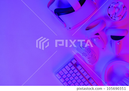 Various modern accessories on purple gaming desk 105690351