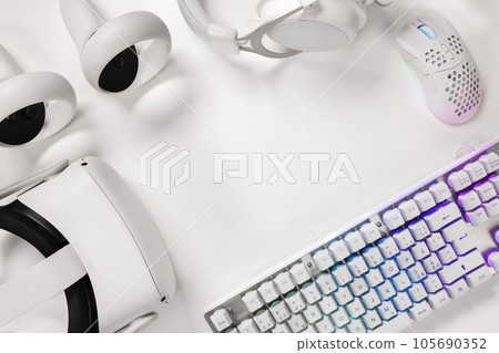 Keyboard with gaming gadgets on white desk 105690352