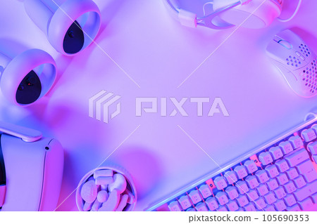 Gaming accessories on purple desk Gaming accessories on purple desk 105690353