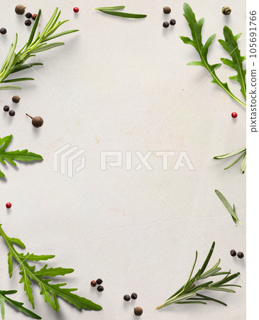 Art frame / border italian cooking background; old parchment with fresh mediterranean herbs leaves; allspice rosemary arugula 105691766