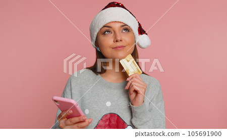 Young woman using credit bank card and smartphone while transferring money purchases online shopping 105691900