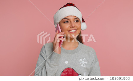 Young woman celebrate Christmas holidays making phone call conversation with friends, best wishes 105691903