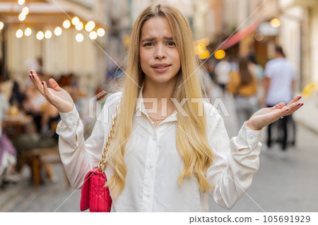 Surprised frustrated young woman raising hands asking reason of failure, demonstrating disbelief Surprised frustrated young woman raising hands asking reason of failure, demonstrating disbelief 105691929
