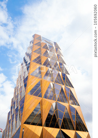 copper red brown pineapple skyscraper on blue cloudy sky. architect Norman Foster. Copper House building copper red brown pineapple skyscraper on blue cloudy sky. architect Norman Foster. Copper House building 105692060