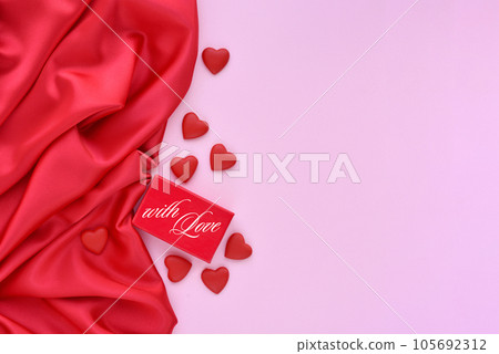Valentines Day background. Red gift box and hearts and red satin fabric with space for your text 105692312