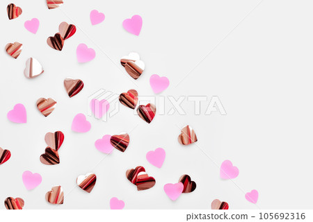 Top view of small paper hearts on white background. Heart shape confetti 105692316