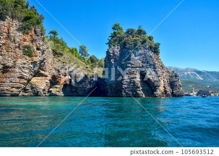 Picturesque view on rocks on a sunny day from the sea. Budva riviera, Montenegro 105693512