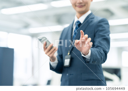 Young new employee male businessman working with smartphone in office Young new employee male businessman working with smartphone in office 105694449