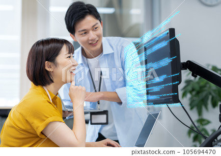 Male and female young engineers having a meeting while operating a personal computer in the office Male and female young engineers having a meeting while operating a personal computer in the office 105694470