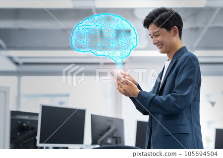 Young male engineer working by operating a smartphone in the office Young male engineer working by operating a smartphone in the office 105694504