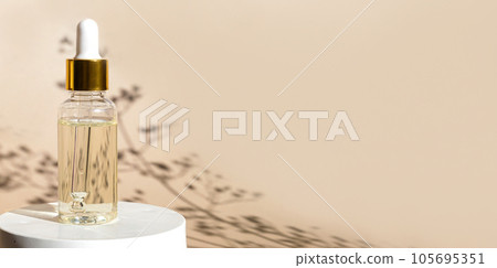 Natural oil cosmetics on neutral background. Dropper glass Bottle Mock-Up. Oily cosmetic pipette. Face and body treatment. Spa concept. Mineral organic oil. Flat lay with beauty products. Blank bottle Natural oil cosmetics on neutral background. Dropper glass Bottle Mock-Up. Oily cosmetic pipette. Face and body treatment. Spa concept. Mineral organic oil. Flat lay with beauty products. Blank bottle 105695351