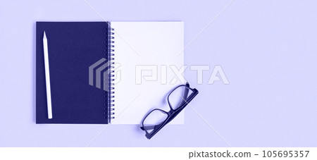 Notebook with pencil, glasses. Open notebook on purple color background, spiral notepad. Top view. Notepad with blank white and black pages for write, office flat lay. Copy Space, Very Peri Notebook with pencil, glasses. Open notebook on purple color background, spiral notepad. Top view. Notepad with blank white and black pages for write, office flat lay. Copy Space, Very Peri 105695357