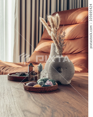 Decorative lava stone vases with dry flowers and healing crystals Decorative lava stone vases with dry flowers and healing crystals 105695424