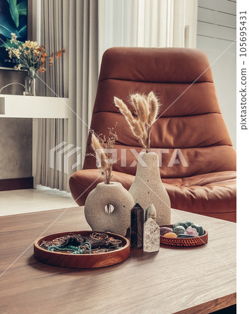 Decorative lava stone vases with dry flowers and healing crystals Decorative lava stone vases with dry flowers and healing crystals 105695431