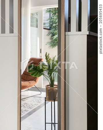 Terracotta armchair in loft style and a house plant 105695433