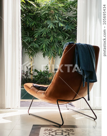 Armchair and view from the living room to the patio 105695434