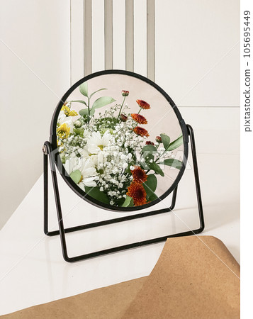 bouquet of chrysanthemums reflected in a mirror 105695449