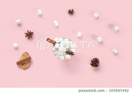 Winter drink, white mug with marshmallows in female hands in knitted Christmas Sweater on pink background. Top view, Flat Lay. New Year, Christmas traditional food. Festive decor, celebration Xmas 105695492