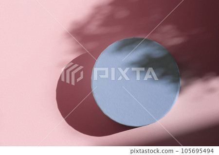 Podium for cosmetic product presentation. Abstract minimal form with geometrical form. Cylinder podium with Floral sunlight shadow. Scene to show products. Showcase, display case. Flat lay, top view Podium for cosmetic product presentation. Abstract minimal form with geometrical form. Cylinder podium with Floral sunlight shadow. Scene to show products. Showcase, display case. Flat lay, top view 105695494