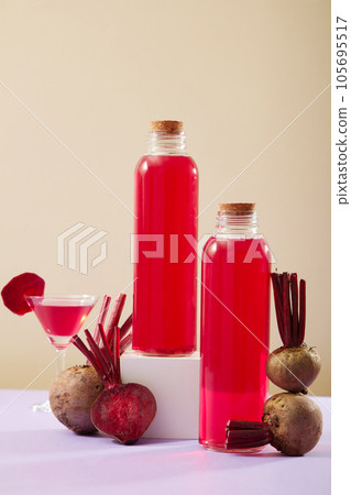 Fresh fruit concept with some beetroots arranged with a glass and unlabeled bottles filled with beetroot juice. The health benefits of Beetroot (Beta vulgaris) has been widely researched Fresh fruit concept with some beetroots arranged with a glass and unlabeled bottles filled with beetroot juice. The health benefits of Beetroot (Beta vulgaris) has been widely researched 105695517