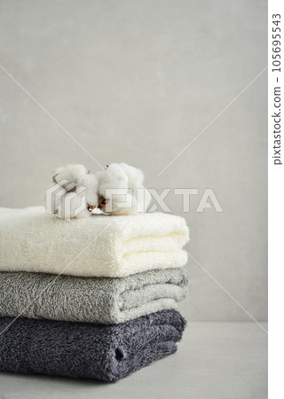 Stack of bath towels with cotton flowers 105695543