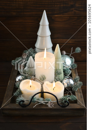 Decorative ceramic fir trees with blue christmas balls and candles Decorative ceramic fir trees with blue christmas balls and candles 105695624