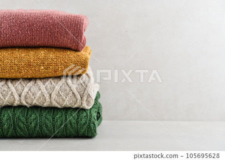 Pile of hand knitted winter clothes Pile of hand knitted winter clothes 105695628