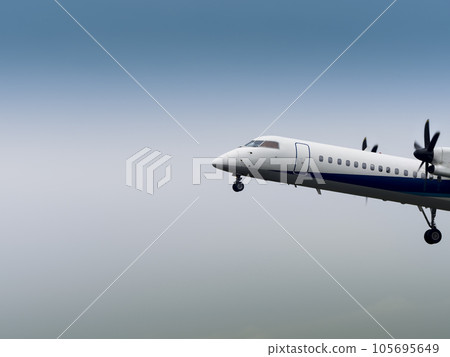 Passenger plane flying in cloudy sky 105695649