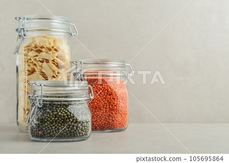Raw mung beans, red lentils and pasta in glass jars. Raw mung beans, red lentils and pasta in glass jars. 105695864