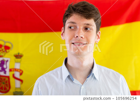 Portrait of positive student against background of flag of Spain Portrait of positive student against background of flag of Spain 105696254