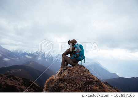 Successful woman hiker hiking at mountain top in tibet 105697166