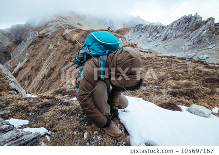 Woman hiker hiking at mountain top in tibet Woman hiker hiking at mountain top in tibet 105697167