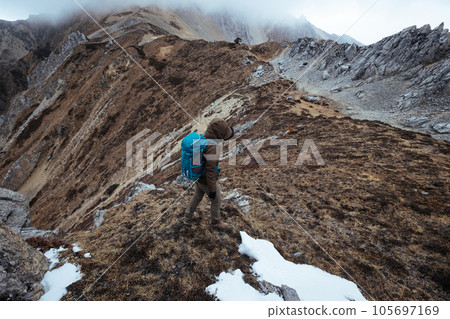 Woman hiker hiking at mountain top in tibet 105697169