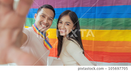 LGBTQIA friends taking selfies together with Pride flag. LGBTQIA f LGBTQIA friends taking selfies together with Pride flag. LGBTQIA f 105697705