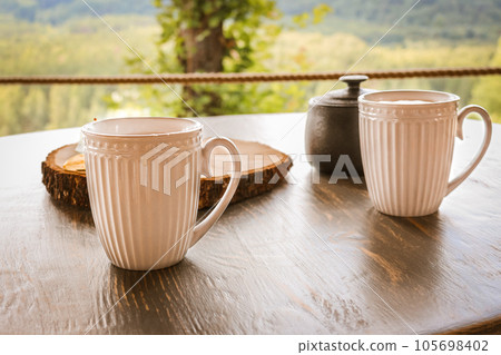 Tasty coffee served in the garden on old wooden table 105698402