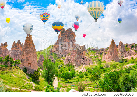 Cappadocia, Turkiye - July 07, 2023-Air balloons in Cappadocia-the ancient Uchisar Castle fortress. Cappadocia, Turkiye - July 07, 2023-Air balloons in Cappadocia-the ancient Uchisar Castle fortress. 105699166