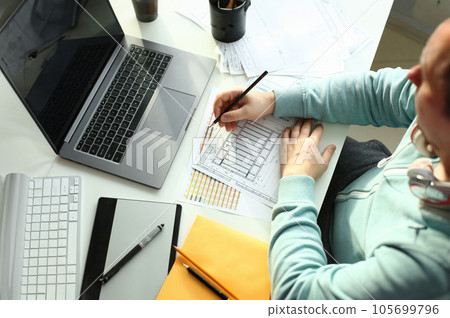 A young designer holds a pen from a tablet in his 105699796