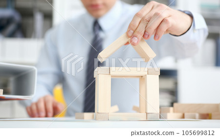 Male hand holds the roof to the lock in 105699812