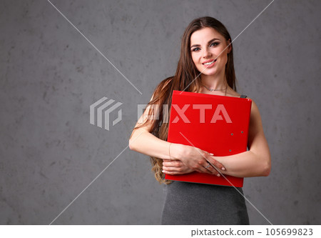 woman holding folder in hand woman holding folder in hand 105699823