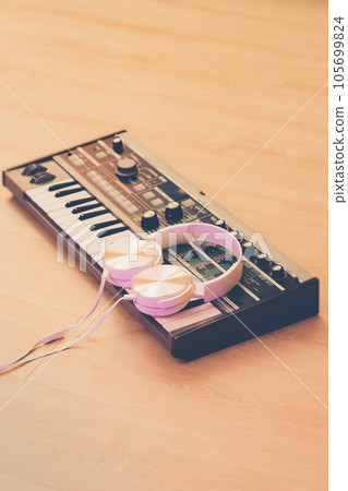 white headphone on synthesizer keyboard. music background white headphone on synthesizer keyboard. music background 105699824