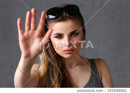 Beautiful young brunette girl wearing sunglasses 105699881