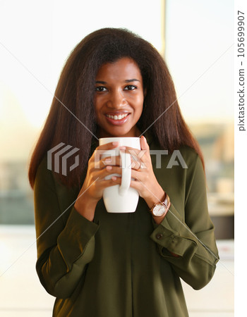 A black woman student in an office holds A black woman student in an office holds 105699907