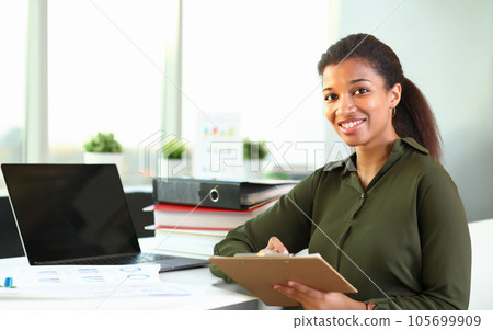 Beautiful smiling businesswoman portrait workplace 105699909