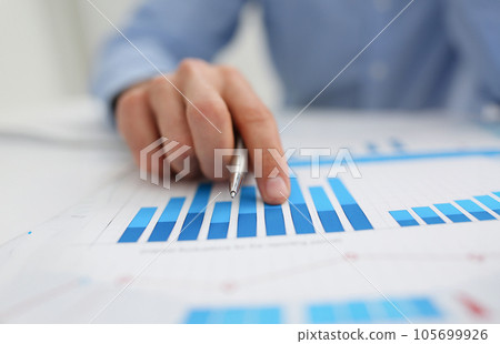 Group of people deliberate on problem with infographics 105699926