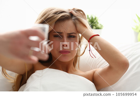 young woman is ill stay in bed have a headacke young woman is ill stay in bed have a headacke 105699954
