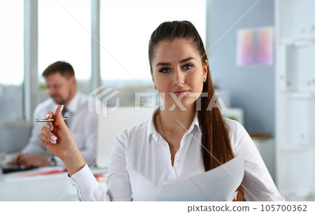 Beautiful smiling cheerful girl at workplace look in camera 105700362