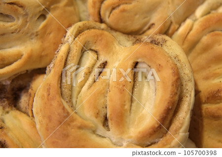 Pastry. Variety of sweet pastry. Bakery shop. Baked products. Freshly toasted buns with cinnamon and sugar rotating on turntable. Breakfast or brunch concept. Baked buns. Top View. Brioche, scone. 105700398