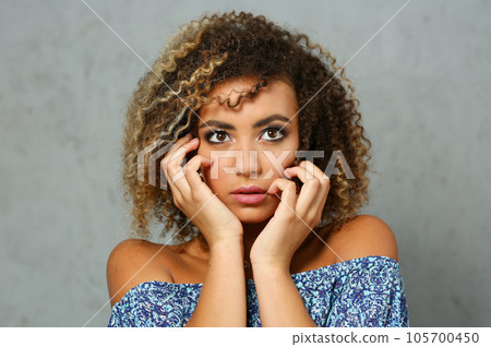 A beautiful black woman portrait. Tests the emotion 105700450